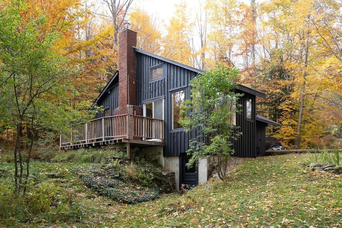 black cottage in woods of vermont